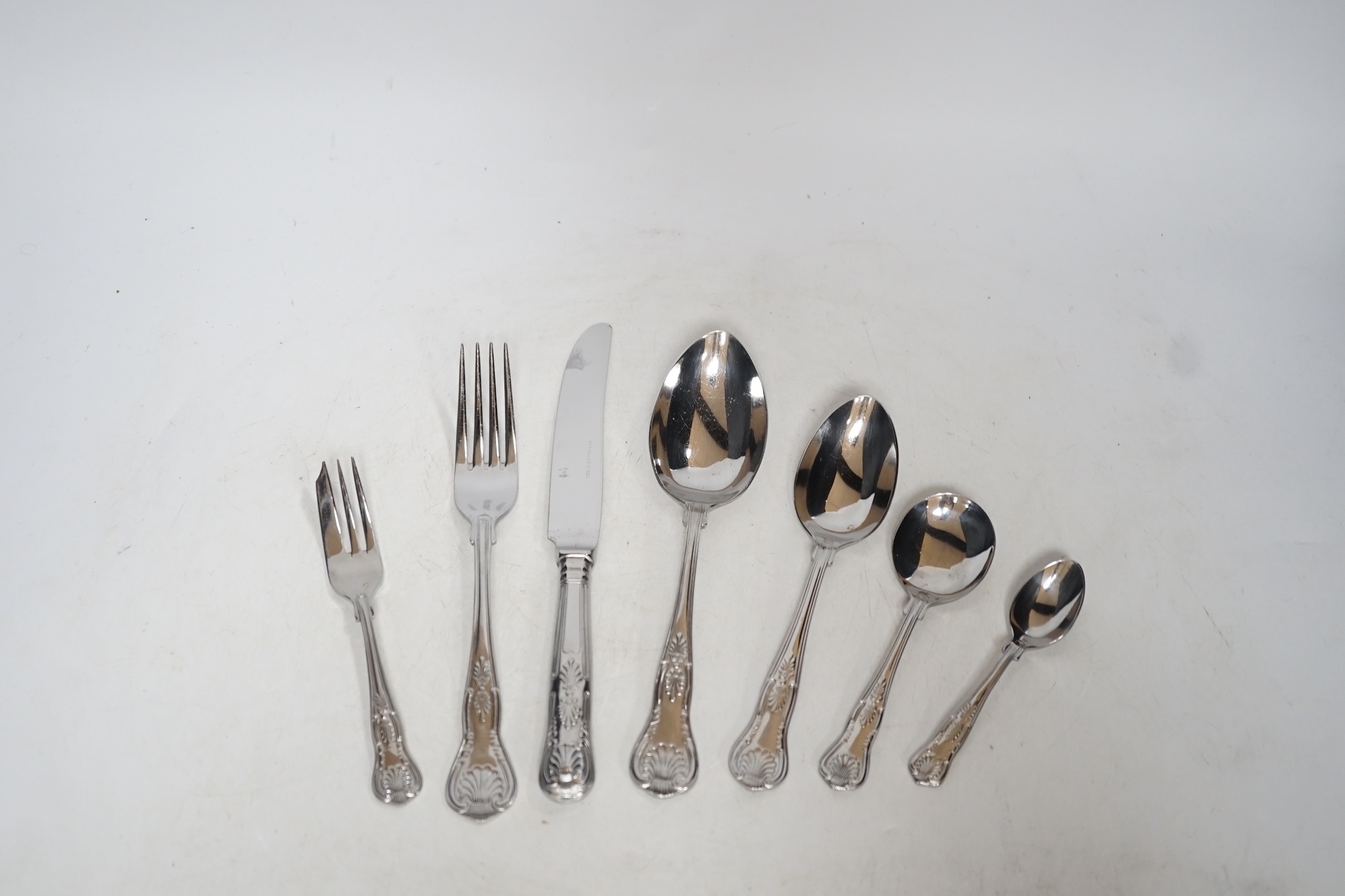 A canteen of plated cutlery with tooled leather top, 77cm wide